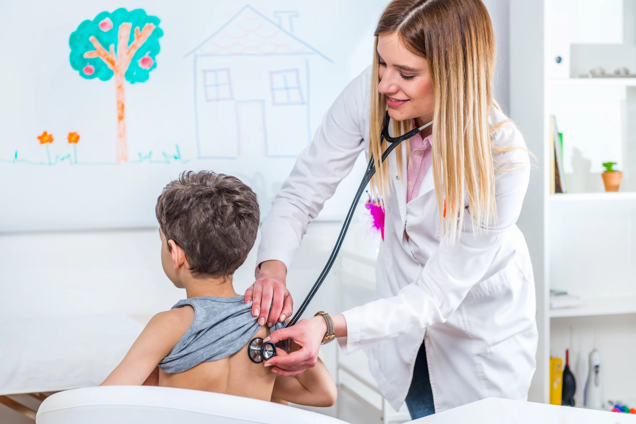 female-doctor-examining-boy-clinic