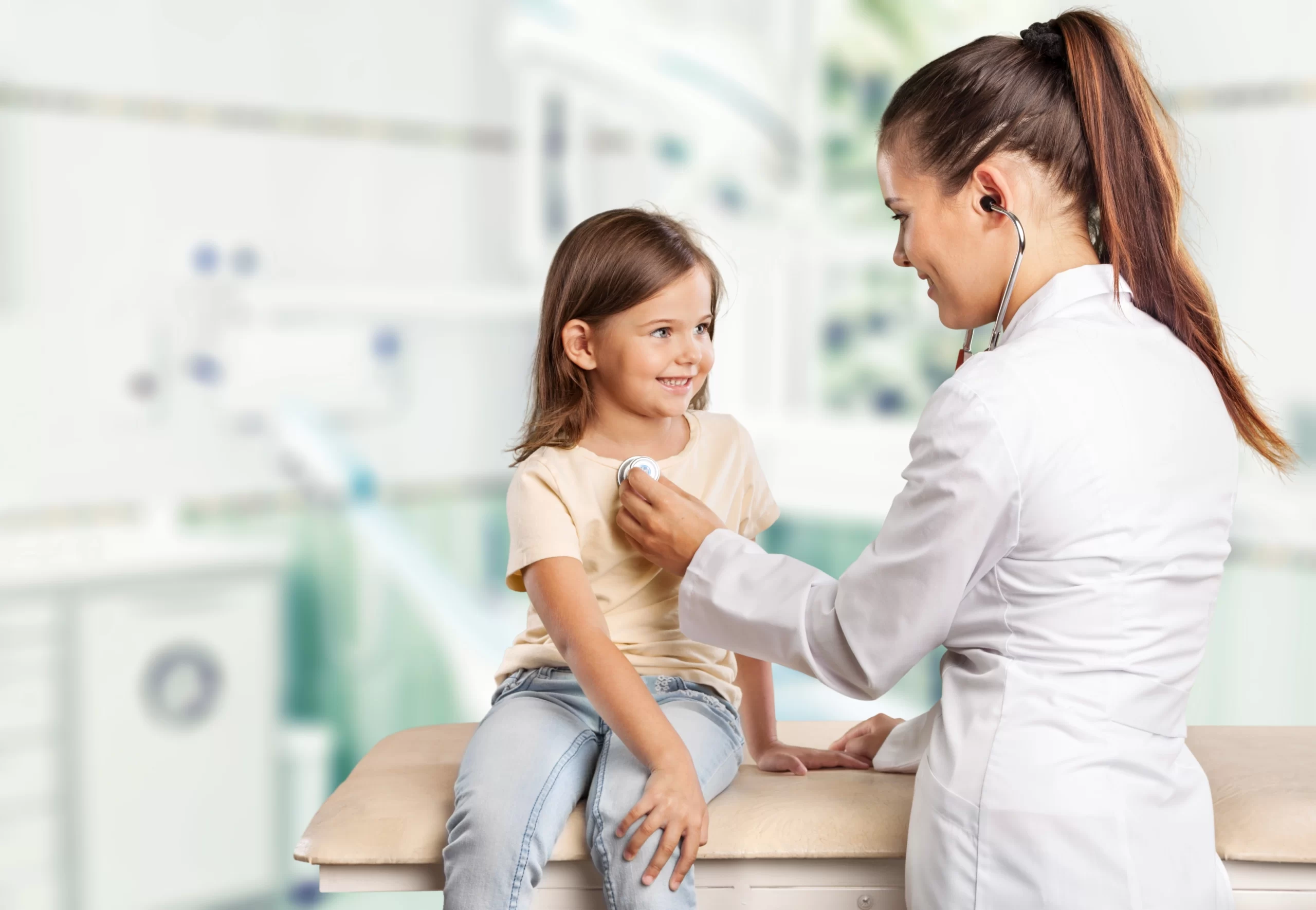 young-woman-doctor-with-little-girl-hospital